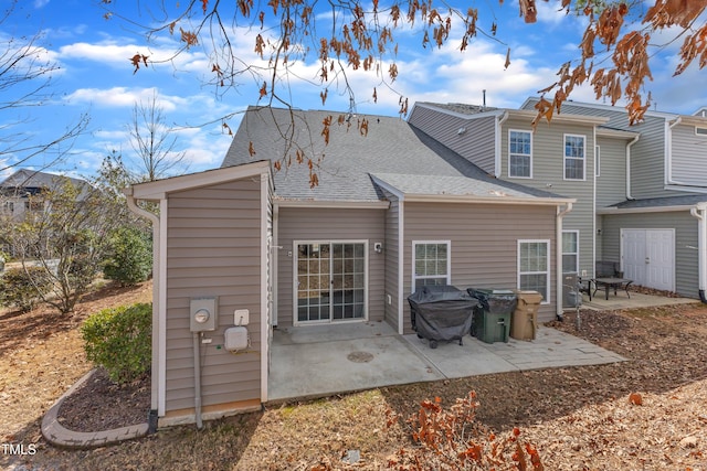 back of house with a patio and a shingled roof