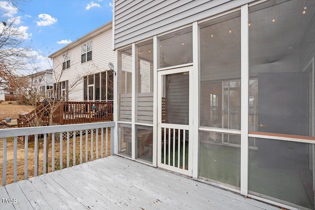 wooden deck featuring a sunroom