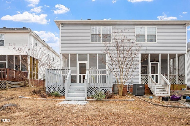 back of property with central air condition unit, a sunroom, and a deck