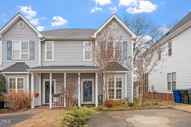 view of front of home with a porch and roof with shingles