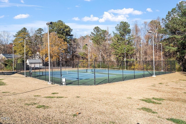 view of tennis court with fence