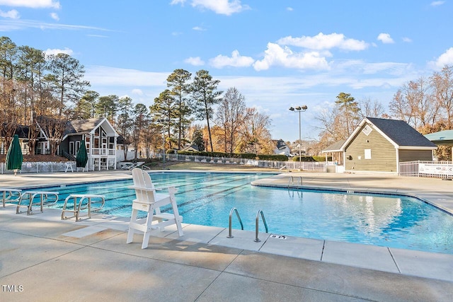 community pool featuring a patio area and fence