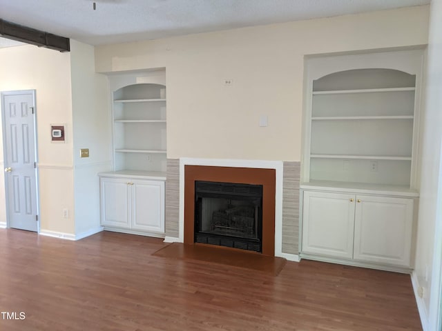 5321 Cog Hill Ct, Raleigh, NC 27604 - unfurnished living room with built in features, baseboards, wood finished floors, and a fireplace