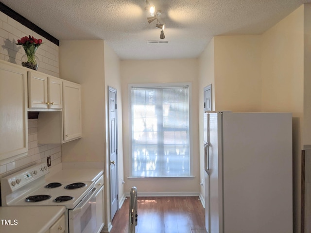 5321 Cog Hill Ct, Raleigh, NC 27604 - kitchen featuring white appliances, wood finished floors, tasteful backsplash, a textured ceiling, and white cabinets