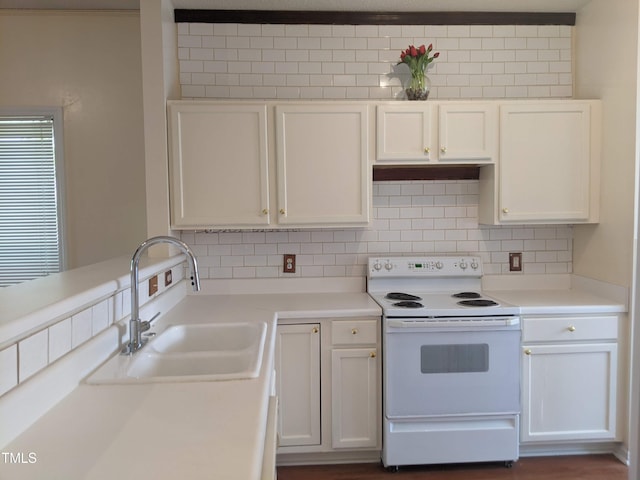 5321 Cog Hill Ct, Raleigh, NC 27604 - kitchen featuring white range with electric stovetop, a sink, tasteful backsplash, and white cabinetry