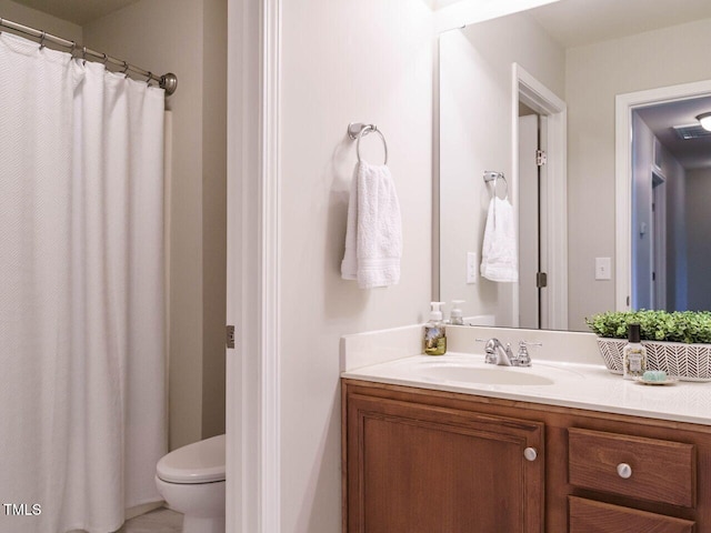 full bathroom with toilet and vanity