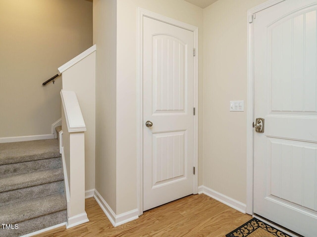 stairway with baseboards and wood finished floors