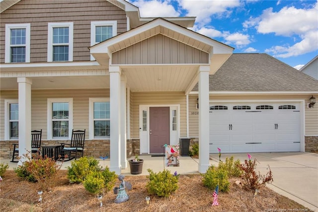 craftsman-style home with a porch, stone siding, and an attached garage