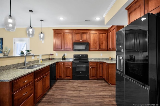 kitchen with ornamental molding, light stone counters, a peninsula, black appliances, and a sink