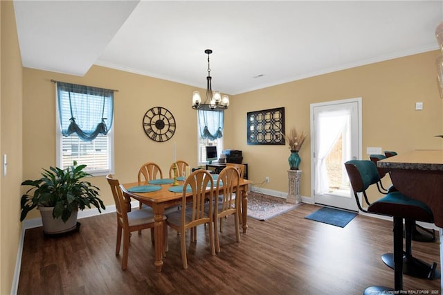 dining space featuring dark wood-style floors, a chandelier, ornamental molding, and baseboards