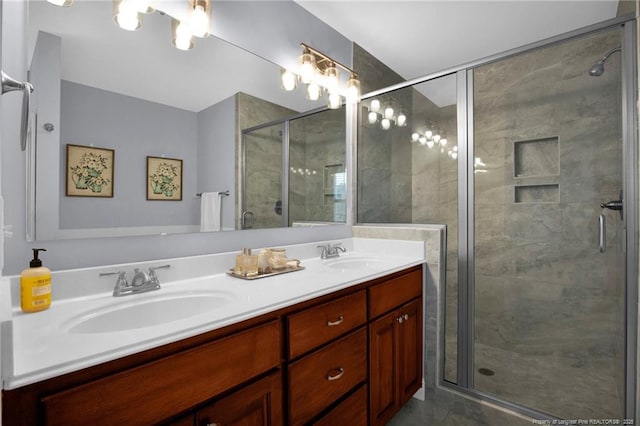 full bathroom featuring a sink, a shower stall, and double vanity