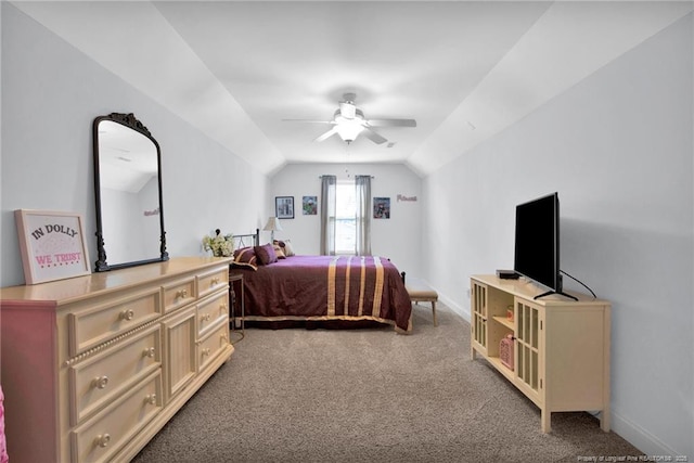 carpeted bedroom featuring vaulted ceiling, baseboards, and ceiling fan