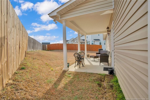 view of yard with a fenced backyard and a patio