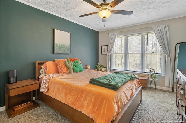 carpeted bedroom featuring crown molding, baseboards, ceiling fan, and a textured ceiling