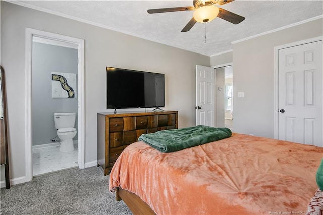 bedroom with a textured ceiling, carpet flooring, baseboards, ornamental molding, and ensuite bath