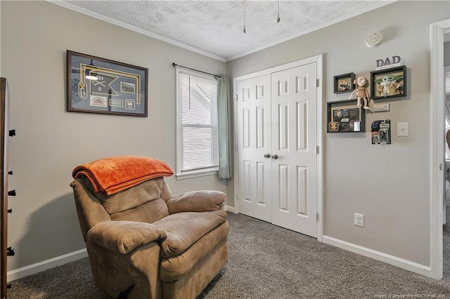 sitting room featuring baseboards, ornamental molding, a textured ceiling, and carpet flooring