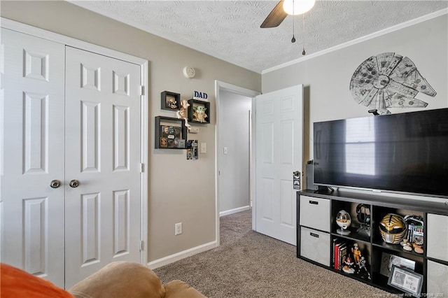 sitting room featuring carpet floors, a textured ceiling, baseboards, and a ceiling fan