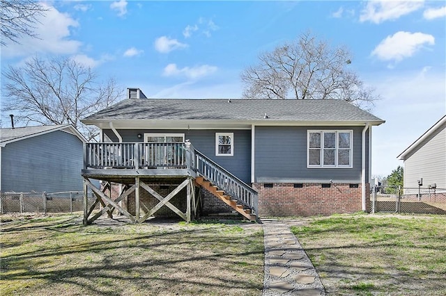 rear view of property featuring stairs, a gate, a deck, and a lawn