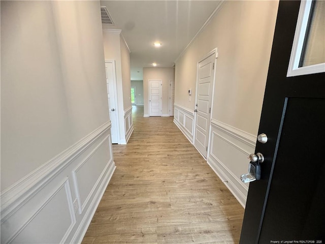 364 Whitestone Dr, Fayetteville, NC 28312 - hallway with ornamental molding, a decorative wall, light wood finished floors, and a wainscoted wall