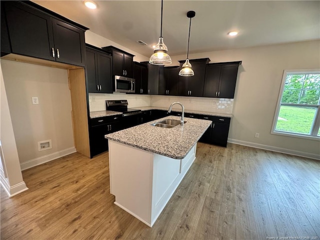 364 Whitestone Dr, Fayetteville, NC 28312 - kitchen featuring stainless steel microwave, electric stove, light stone counters, light wood-type flooring, and recessed lighting