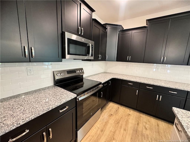 364 Whitestone Dr, Fayetteville, NC 28312 - kitchen with stainless steel appliances, light wood-style flooring, tasteful backsplash, and light stone countertops