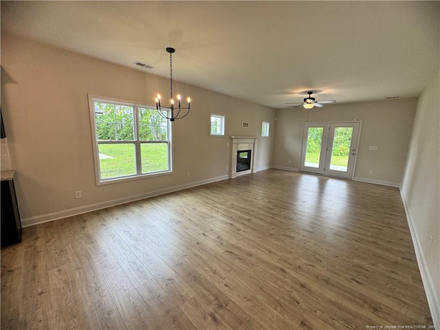 364 Whitestone Dr, Fayetteville, NC 28312 - unfurnished living room featuring wood finished floors, a chandelier, ceiling fan, and a glass covered fireplace