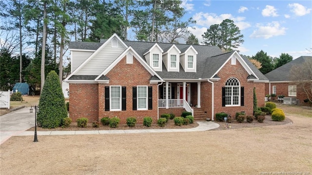 view of front facade featuring a shingled roof and brick siding