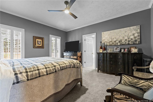 carpeted bedroom featuring a textured ceiling, ornamental molding, and a ceiling fan