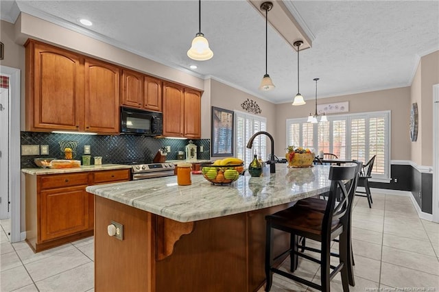 kitchen featuring black microwave, brown cabinets, stainless steel electric range, and light tile patterned floors