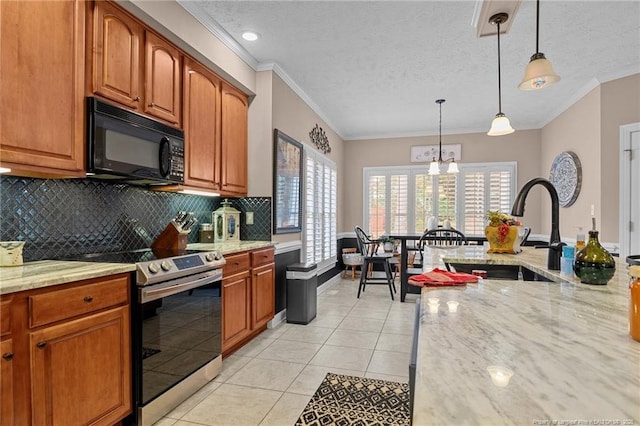 kitchen with hanging light fixtures, a healthy amount of sunlight, stainless steel range with electric stovetop, black microwave, and light tile patterned flooring