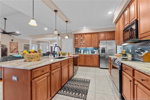 kitchen featuring light stone counters, brown cabinets, a sink, and black appliances