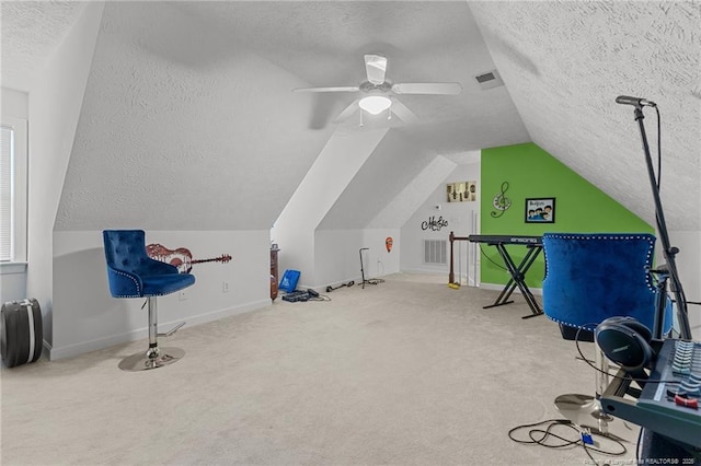 interior space with carpet floors, visible vents, and a textured ceiling