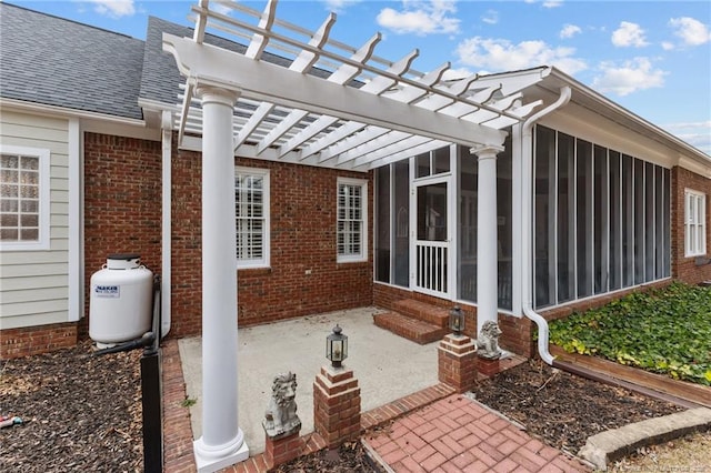 view of patio with a sunroom and a pergola