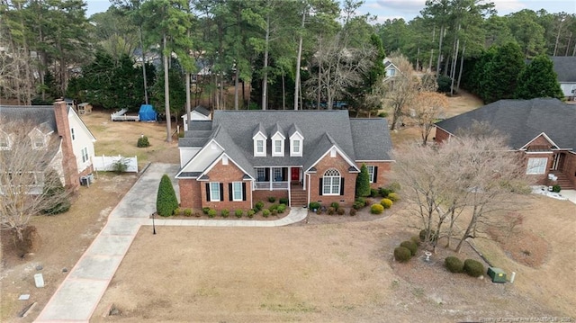 view of front facade with driveway and brick siding