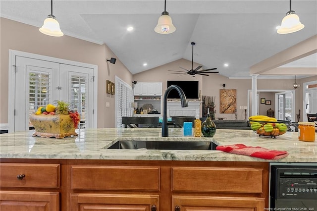 kitchen featuring open floor plan, wine cooler, a sink, and a healthy amount of sunlight