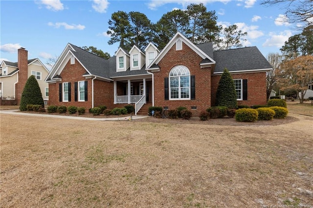 view of front facade with crawl space, brick siding, and a front lawn