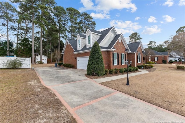 view of side of property with a garage, brick siding, and driveway