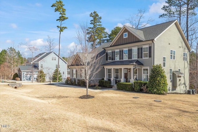 view of front of property with a front lawn, central air condition unit, and board and batten siding