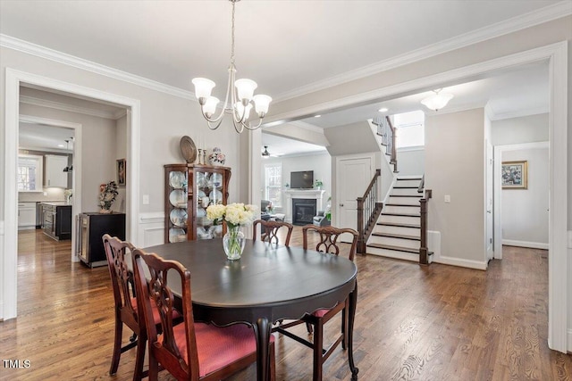 dining area with plenty of natural light, a fireplace, and wood finished floors