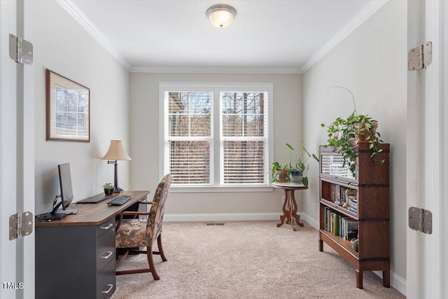 office with visible vents, light colored carpet, baseboards, and ornamental molding