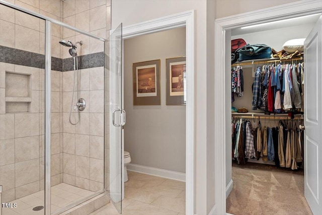 full bath featuring a spacious closet and a shower stall