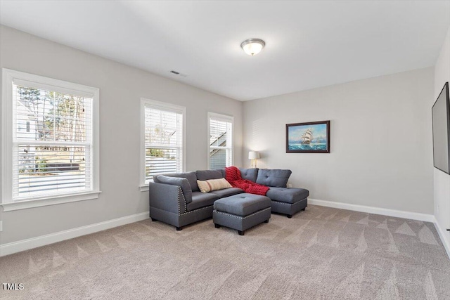 living room with visible vents, baseboards, and carpet floors