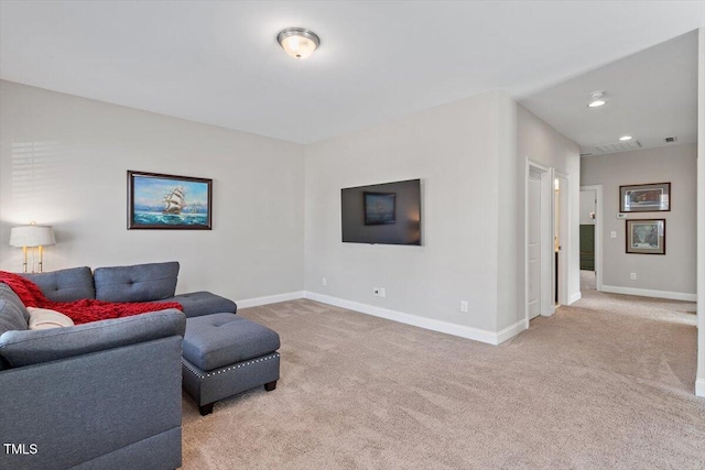 carpeted living area featuring recessed lighting and baseboards