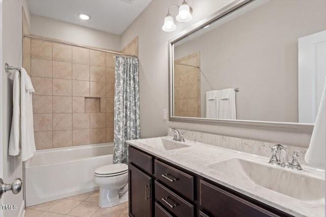 full bath featuring tile patterned floors, shower / tub combo, toilet, and a sink