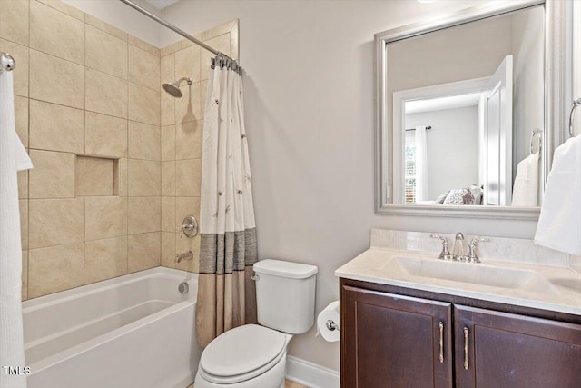 bathroom featuring toilet, vanity, and shower / bath combo