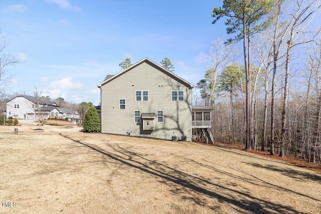 back of property with a sunroom