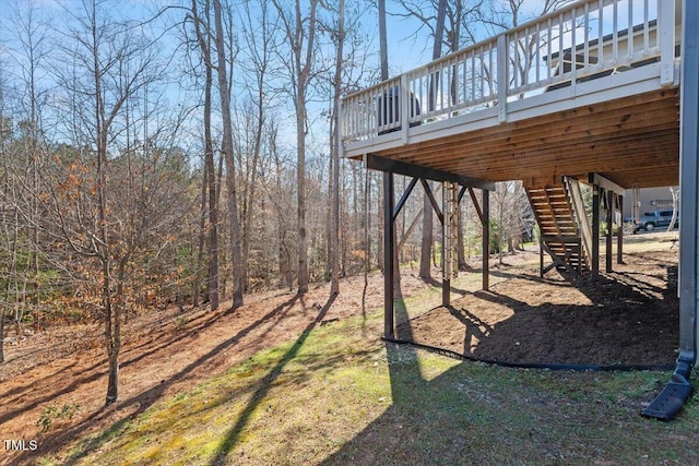 view of yard featuring a deck and stairs