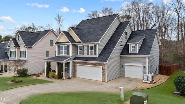 view of front of house featuring concrete driveway, a garage, and a front yard