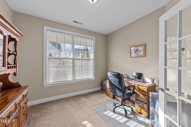 office with visible vents, light colored carpet, and baseboards