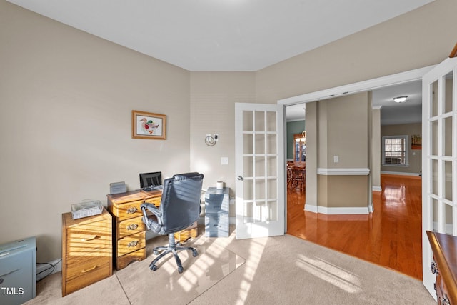 home office with french doors, baseboards, and wood finished floors